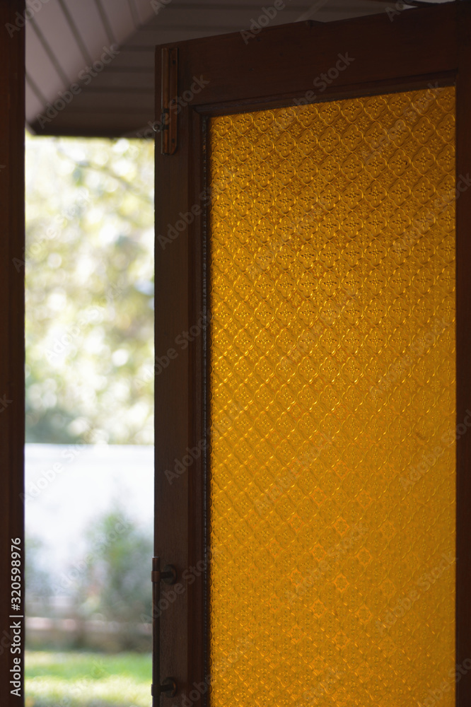 Teak wooden window frames with color glass Teak wooden window frames with color glass