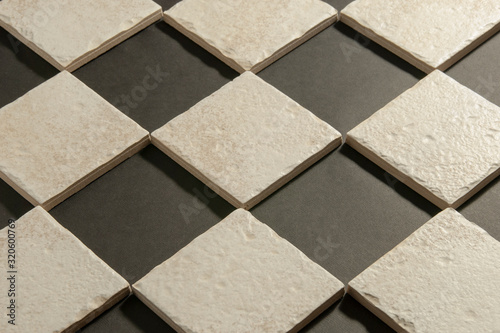 white ceramic tiles for the kitchen, bathroom, for the floor on a black background for the advertising campaign.