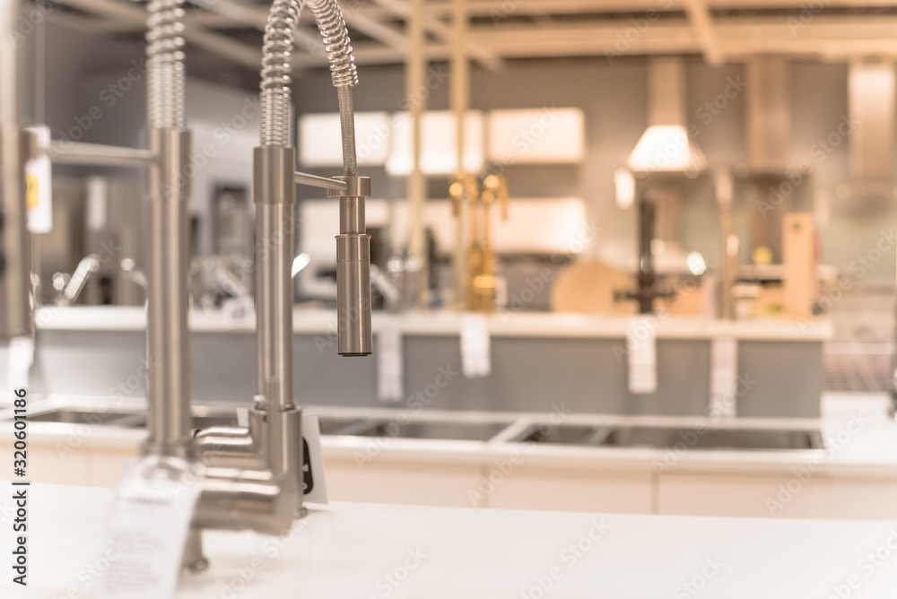 Shiny kitchen faucets with pull-out sprout at furniture showroom in Texas, USA Shiny kitchen faucets with pull-out sprout at furniture showroom in Texas, USA