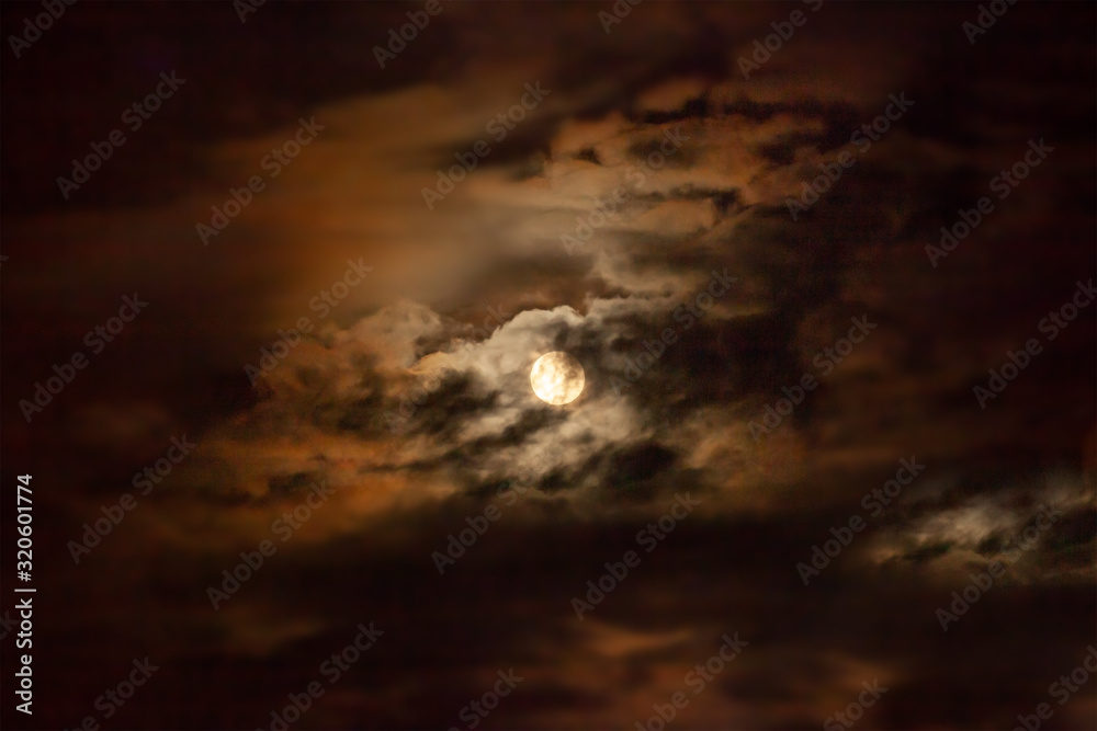 Full moon and clouds at midnight. Dramatic moonscape Full moon and clouds at midnight. Dramatic moonscape