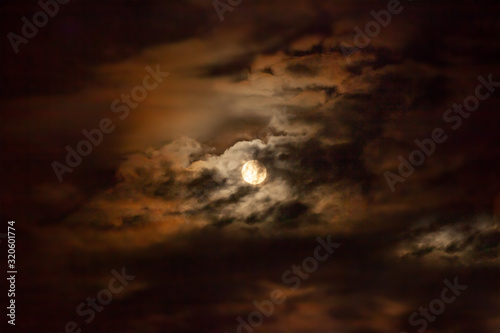 Full moon and clouds at midnight. Dramatic moonscape