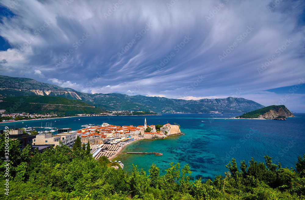 Aerial panoramic view of Old town Budva: Ancient walls and red tiled roof. Montenegro, Europe. One of best preserved medieval cities in the Mediterranean and most popular resorts of Adriatic Riviera..