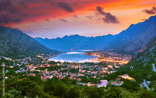 Fantastic aerial panoramic summer view from the mountain to the bay of Kotor Mediterranean Balkans, Montenegro, Europe. Traveling concept background. Incredible street lights in the sunrise. Postcard.