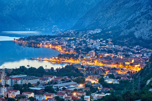 Fantastic aerial panoramic summer view from the mountain to the bay of Kotor Mediterranean Balkans, Montenegro, Europe. Traveling concept background. Incredible street lights in the sunrise. Postcard.