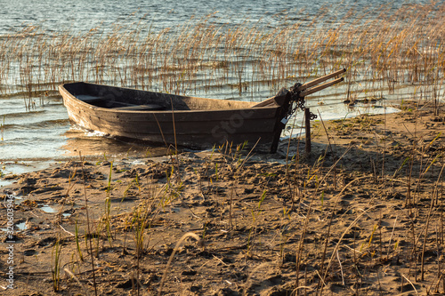Boat moored on the mudy shore lake photo
