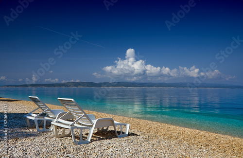 Fototapeta Naklejka Na Ścianę i Meble -  Amazing seascape of Adriatic sea. Colorful summer view of small Brela beach Croatia, Europe. Croatian coast with clear water and pine trees around. Tropical viewpoint for design postcard.