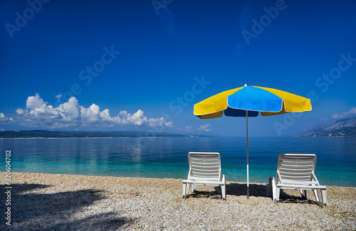 Amazing seascape of Adriatic sea. Colorful summer view of small Brela beach Croatia, Europe. Croatian coast with clear water and pine trees around. Tropical viewpoint for design postcard.