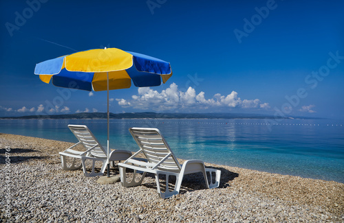 Amazing seascape of Adriatic sea. Colorful summer view of small Brela beach Croatia, Europe. Croatian coast with clear water and pine trees around. Tropical viewpoint for design postcard.