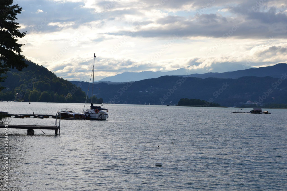 view to a lake at sunset with boats