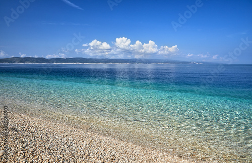Amazing seascape of Adriatic sea. Colorful summer view of small Brela beach Croatia, Europe. Croatian coast with clear water and pine trees around. Tropical viewpoint for design postcard.