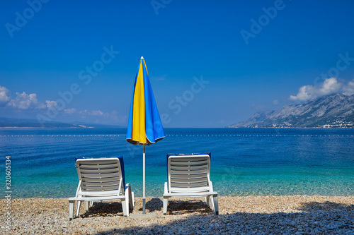 Amazing seascape of Adriatic sea. Colorful summer view of small Brela beach Croatia, Europe. Croatian coast with clear water and pine trees around. Tropical viewpoint for design postcard.
