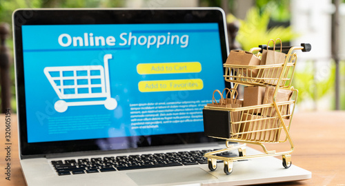 Online shopping and iot(internet of things) concept.Boxes in a trolley on a laptop. Ideas for online shopping,online shopping is consumers to directly buy goods from a seller over the internet.