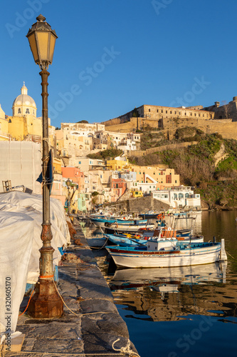 Procida (Italy) - View of Corricella bay in the sunset light, a romantic village of fishermen in Procida, Italy photo