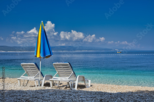 Amazing seascape of Adriatic sea. Colorful summer view of small Brela beach Croatia, Europe. Croatian coast with clear water and pine trees around. Tropical viewpoint for design postcard.