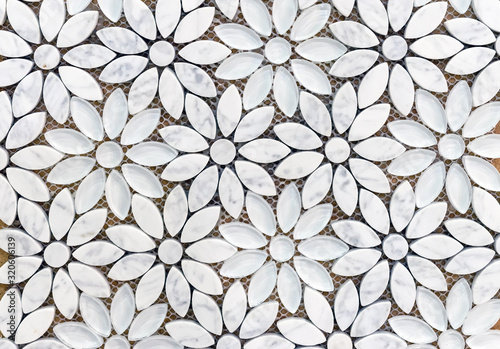 Marble tiles mosaic in the shape of flowers. Background of white marble flowers.