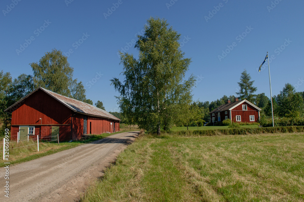 old wooden house in the countryside with red barn old wooden house in the countryside with red barn
