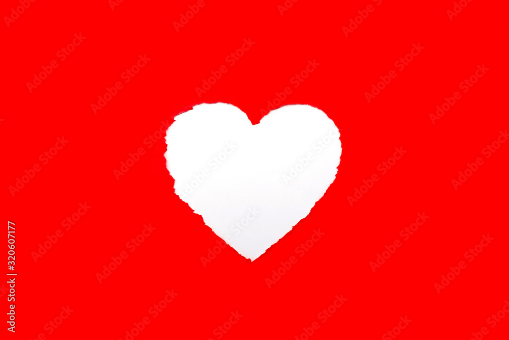 Torn heart shaped in red paper and blue background