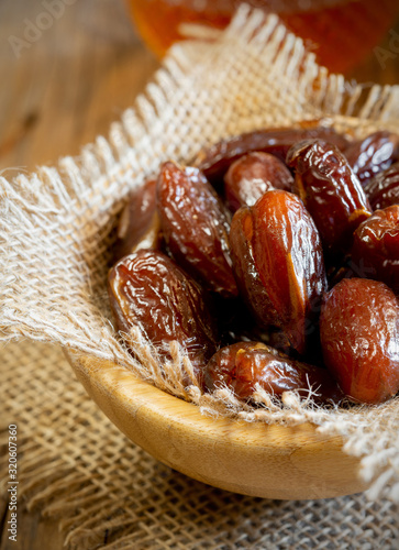 dry sweet dates on wooden table