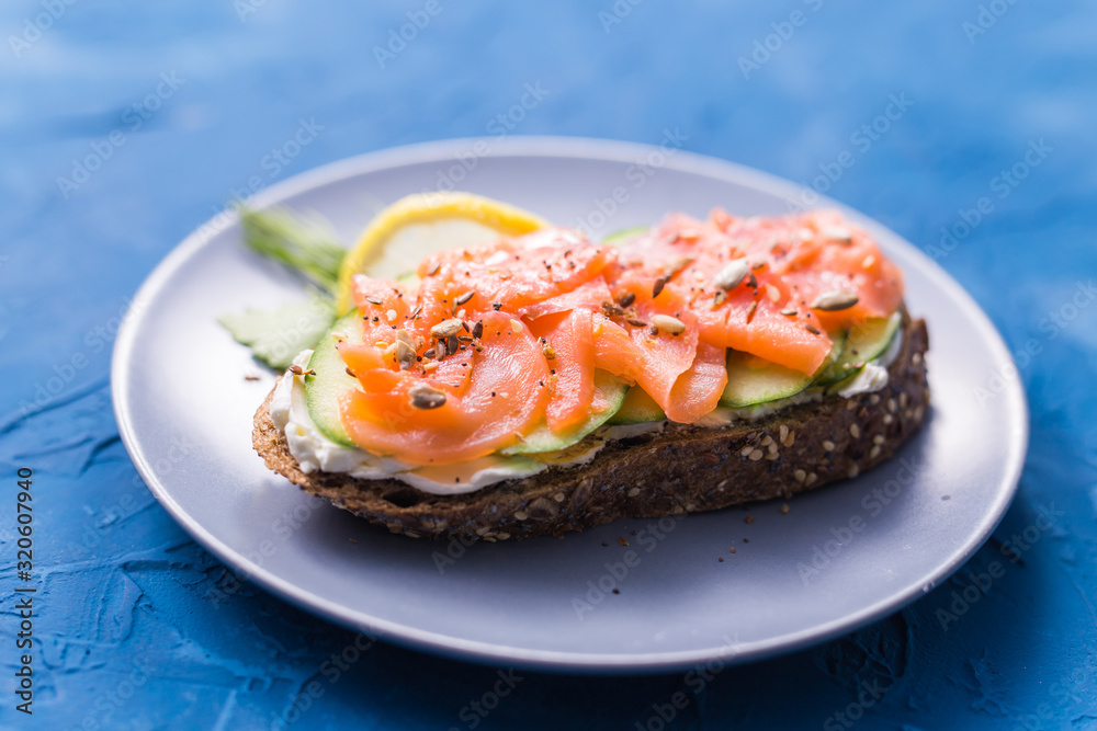 Sandwich with smoked salmon and cucumber. Concept for healthy nutrition.