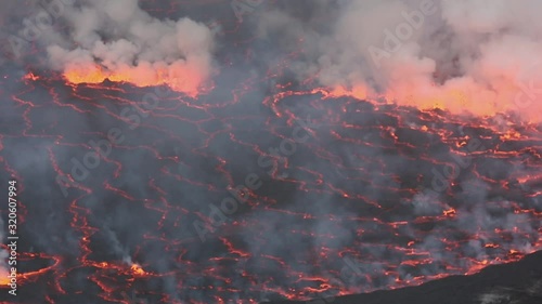 Bubbling lava and smoke in a round crater of Nyiragongo volcano, Congo