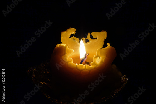 Burning Christmas candle cast from beeswax