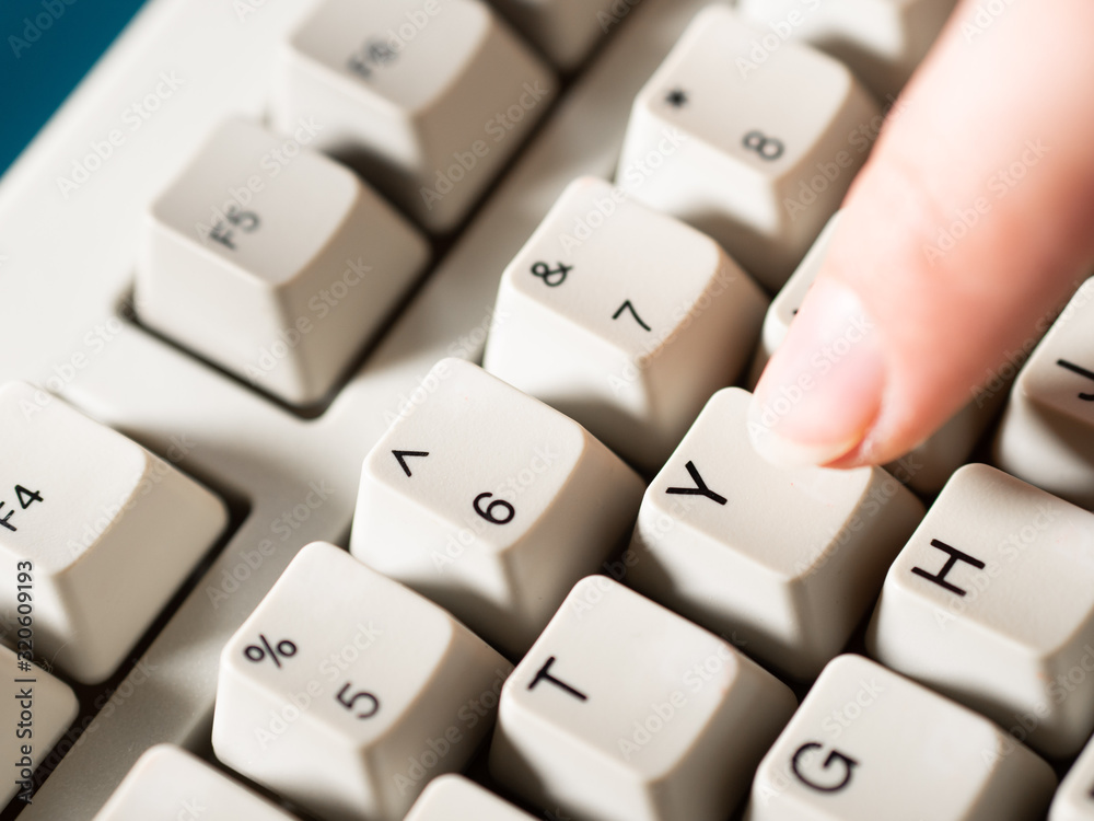 Female forefinger pushes Y button. Close-up Female forefinger pushes Y button. Close-up