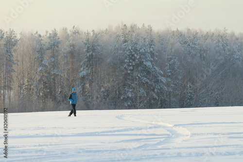 Man in winter sportswear skiing on snowy slope.