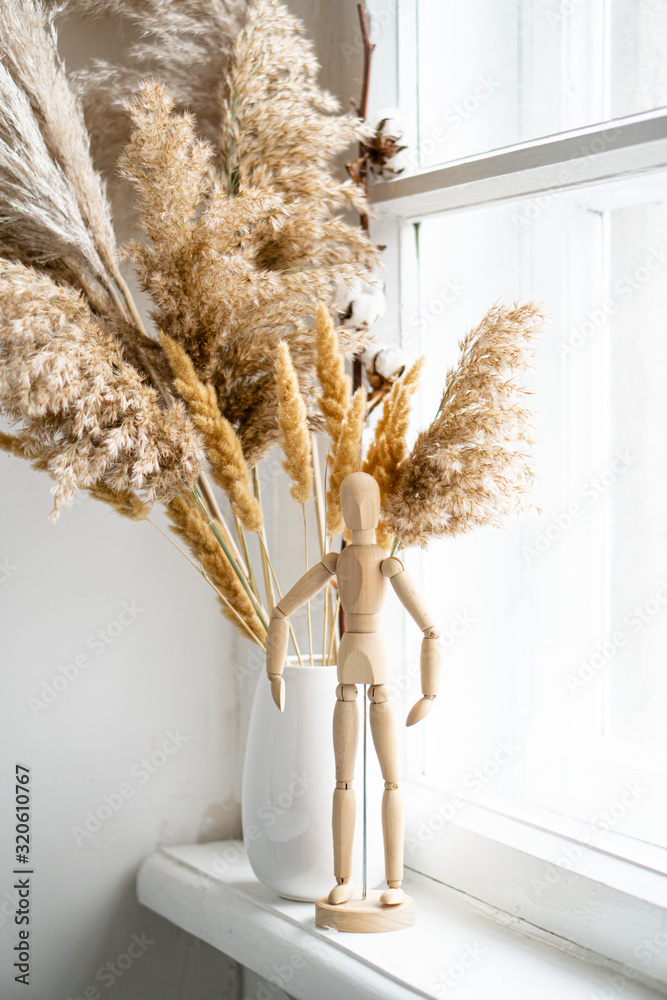 Plakat Dry reeds in ceramic vase on windowsill, vintage home interior