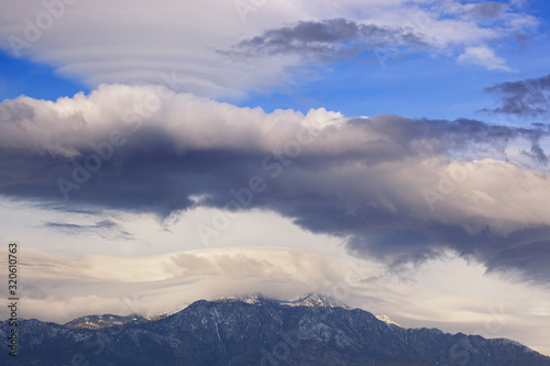 Winter landscape of lenticular clouds floating above the San Bernardino Mountains  Palm Springs  California  USA