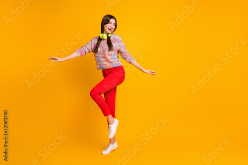 Full size photo of funky dreamy dream girl enjoy listen headset music dance dancer clubbing on disco floor wear good look sweater shoes isolated over shine color background