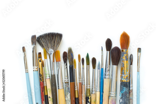 Used artistic paintbrushes isolated on white background. Close up shot of artist's equipment. Copy space