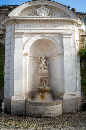  The angel ,Large ornate  stone fountain  , Dei gratia inter alia lucet ( Traslation , by the grace of god  she shines for us all  )°perne les fontaines provence south of France. photo