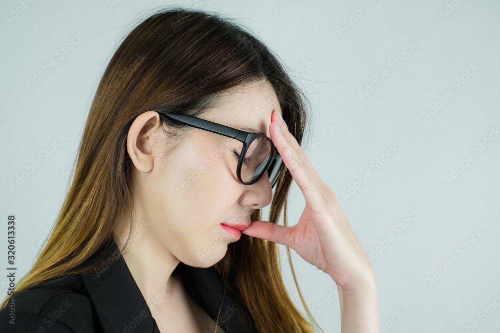 side of stressed asian business woman. ware a glasses. Caucasian female model isolated on white background.