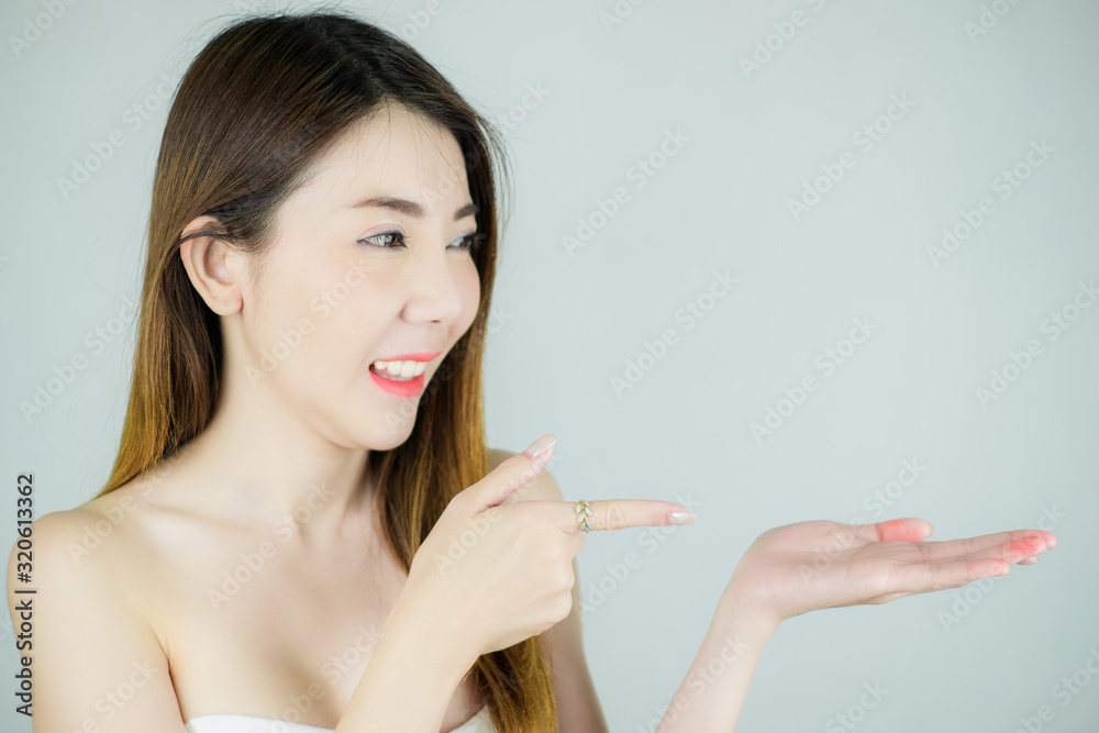portrait beautiful young asian woman with smooth health fresh skin. showing empty hand for display product. Copy space ready. isolated on white background. skin care, healthy concept. portrait beautiful young asian woman with smooth health fresh skin. showing empty hand for display product. Copy space ready. isolated on white background. skin care, healthy concept.
