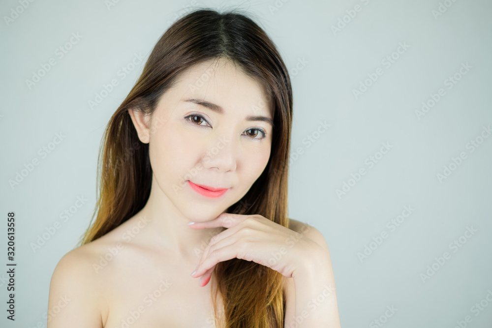 Close-up beautiful face of young asian woman with smooth health fresh skin. Touching her cheek. Isolated on white background. Skin care concept. Close-up beautiful face of young asian woman with smooth health fresh skin. Touching her cheek. Isolated on white background. Skin care concept.