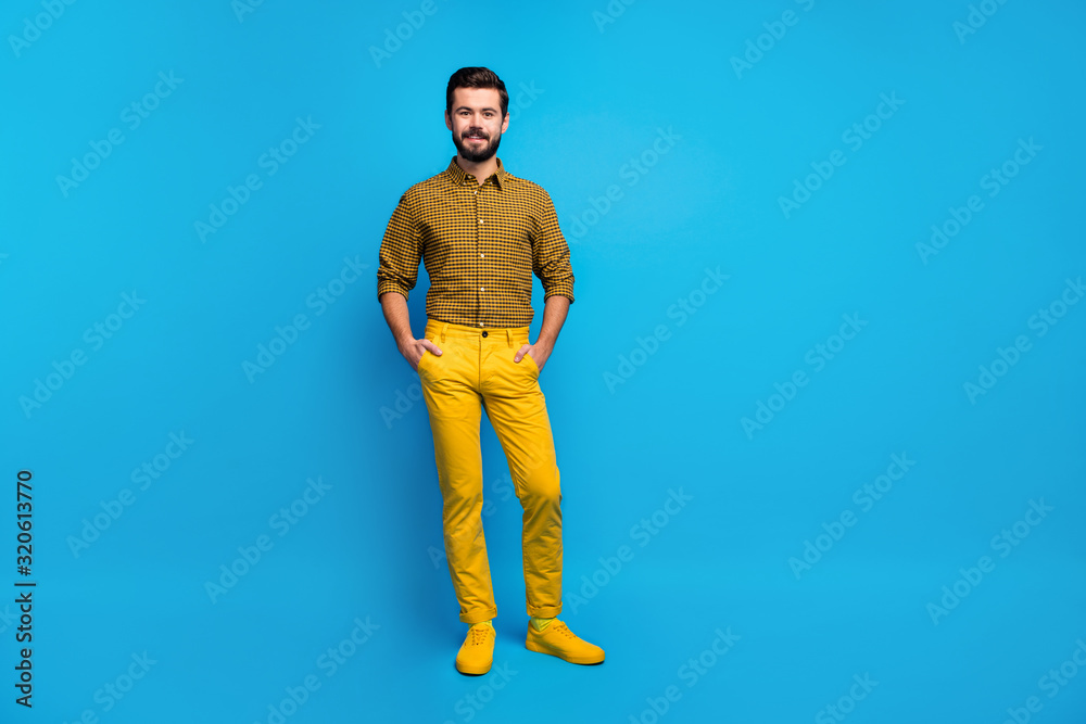 Full size photo of content candid guy enjoy spring free time holiday put hands pocket wear stylish colorful outfit footwear isolated over vibrant color background