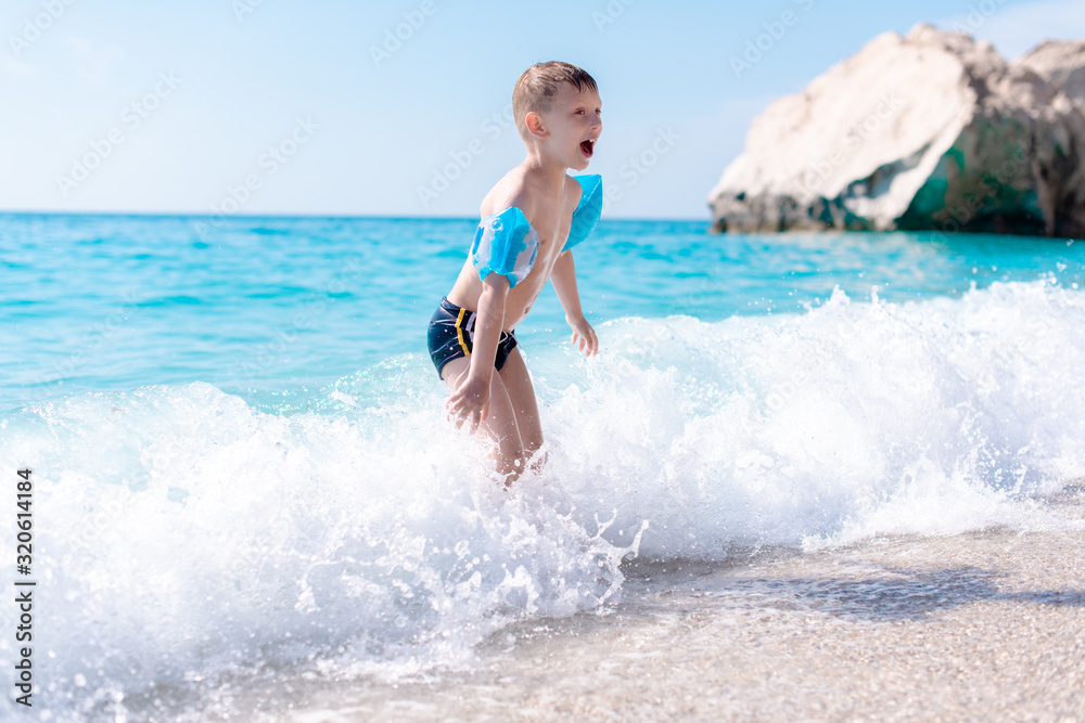 One boy is playing on the beach One boy is playing on the beach