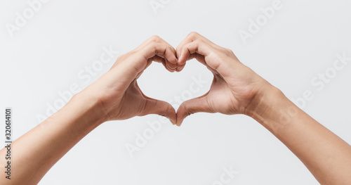Billede på lærred Man hands making a heart shape on a white isolated background