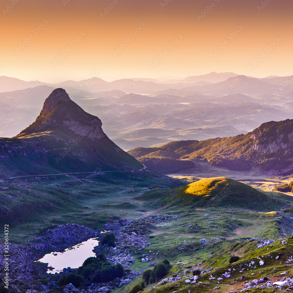 Amaizing sunset view on Durmitor mountains, National Park, Mediterranean, Montenegro, Balkans, Europe.  Bright summer view from Sedlo pass. Instagram picture. Way through the mountain.