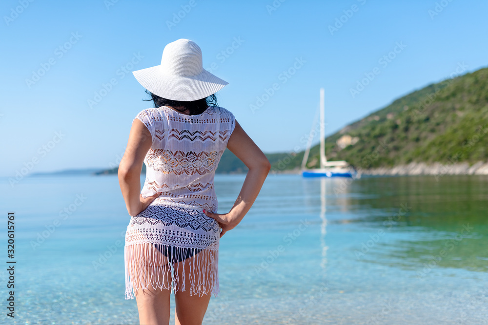 A woman is looking into the water