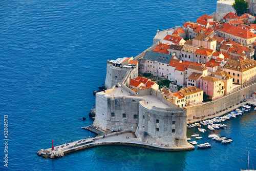 Fototapeta Naklejka Na Ścianę i Meble -  Aerial view at famous european travel destination in Croatia, Dubrovnik old town, Dalmatia, Europe. UNESCO list. Beautiful sunset view over the historic old Fort Bokar seen in dramatic light. Roofs