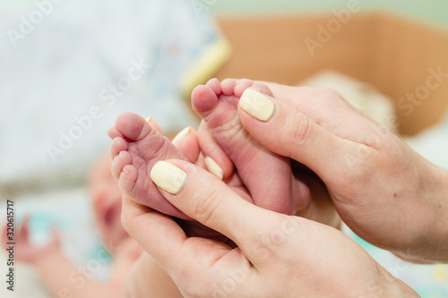 Newborn baby's feet in parents' hands