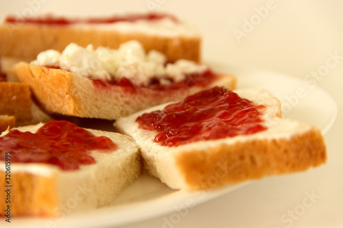 Sandwiches with butter, jam and cottage cheese.