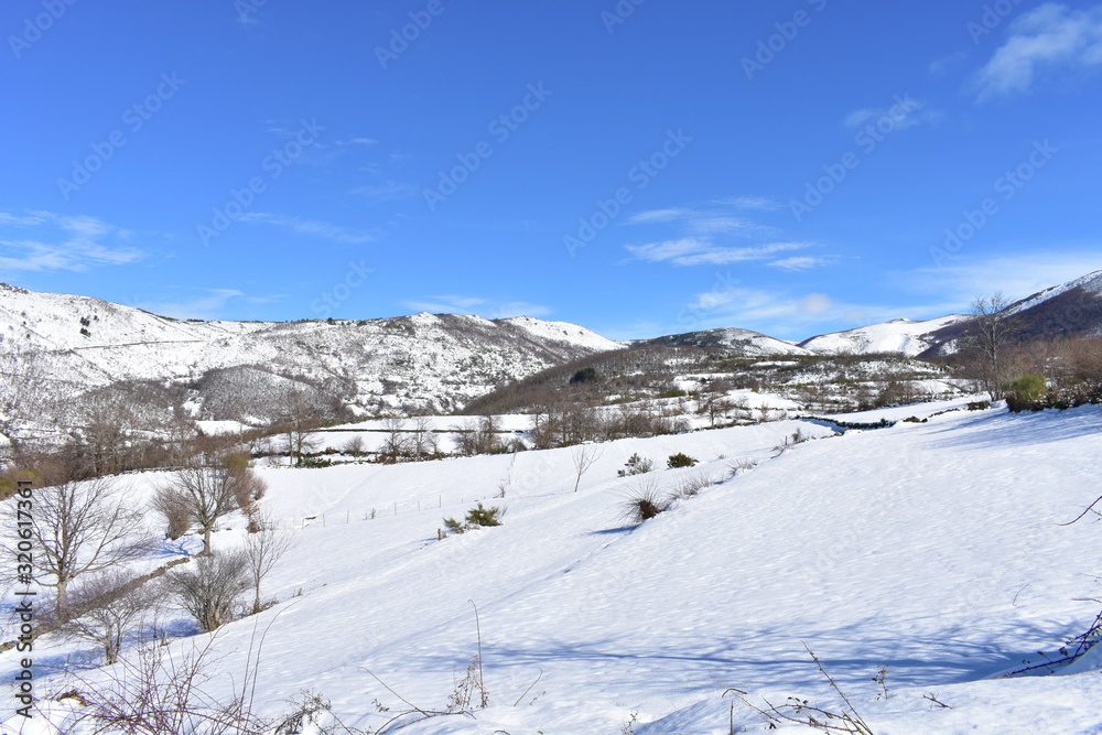 Winter landscape with white snowy mountains and blue sky. Piornedo, Ancares, Lugo, Galicia, Spain.