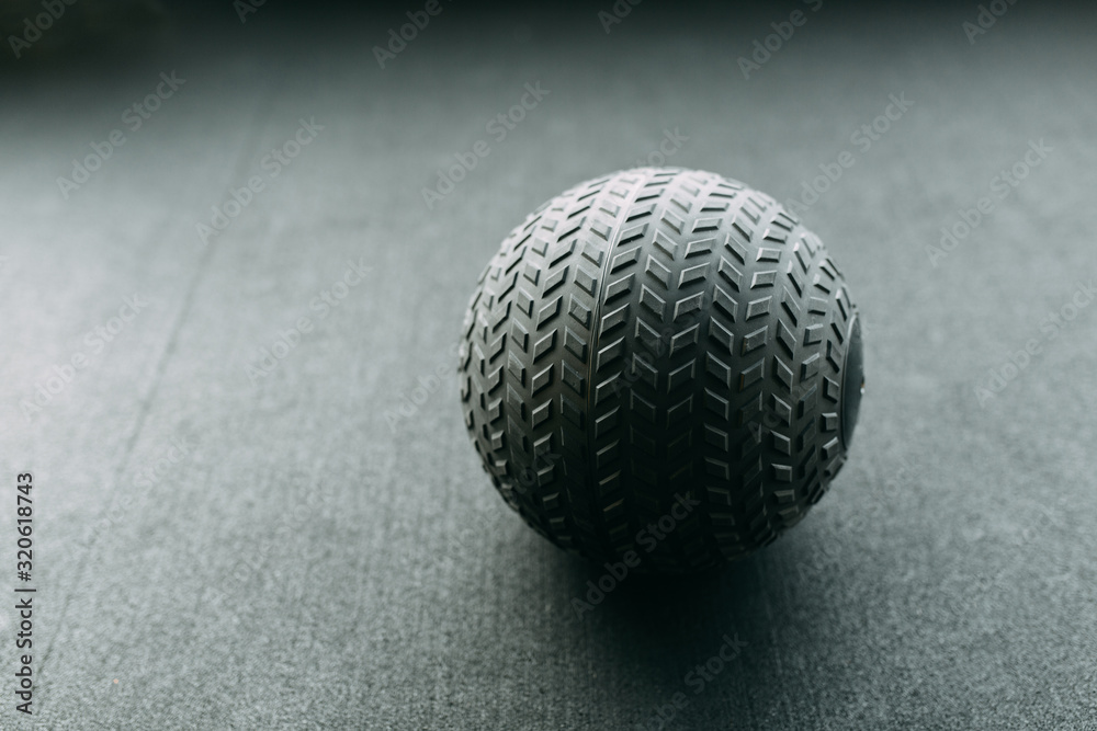 For warm-up and training. Black ball for exercise in the gym.