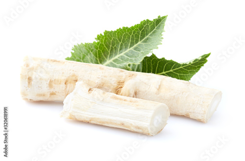 Horseradish root with leaves on white background