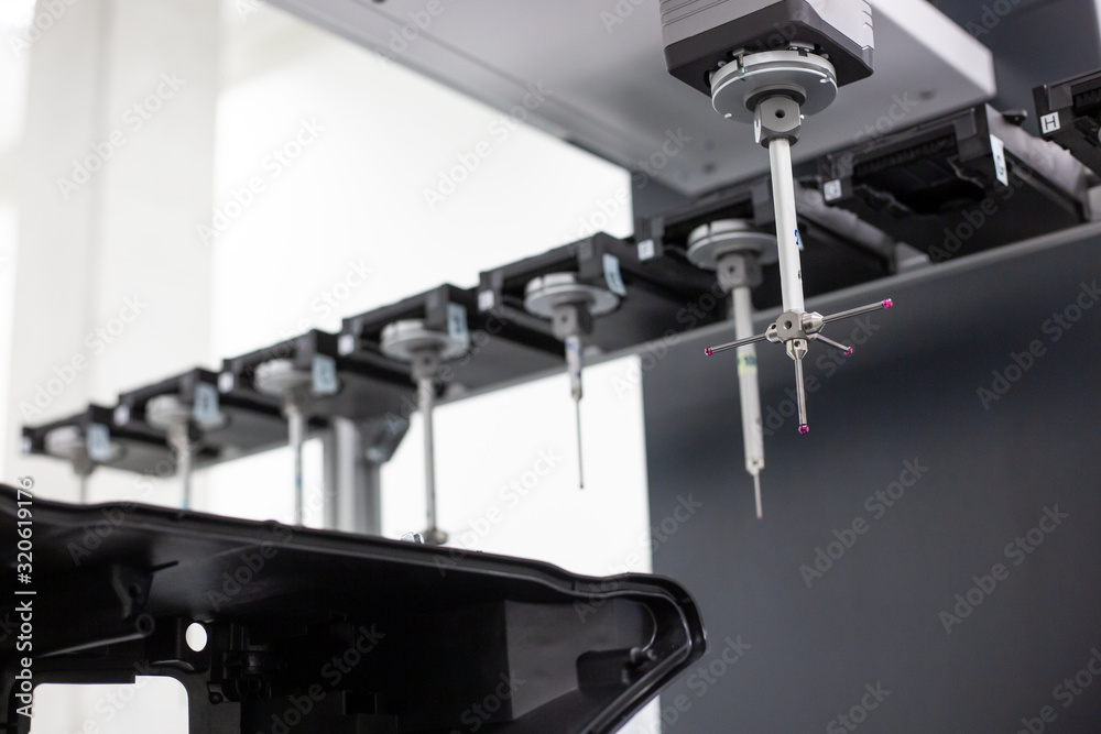 Close up of professional automatic 3D measuring system machine for plastic moldings, industrial and automotive concept Close up of professional automatic 3D measuring system machine for plastic moldings, industrial and automotive concept