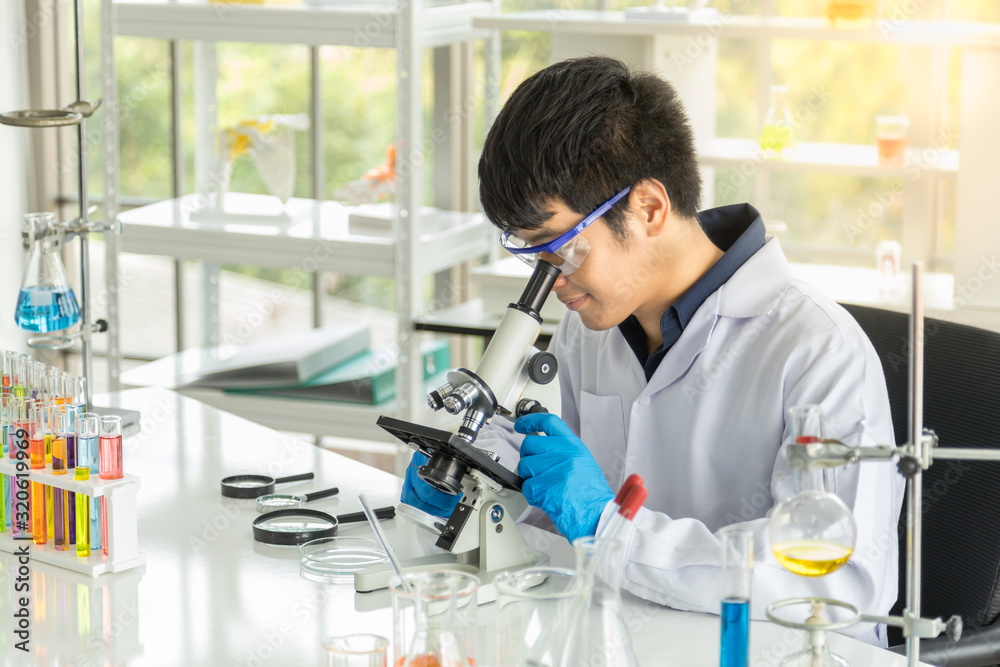 Portrait of asian professional young doctor scientist using microscope and research in working laboratory. Science and Healh Care Concept. Portrait of asian professional young doctor scientist using microscope and research in working laboratory. Science and Healh Care Concept.