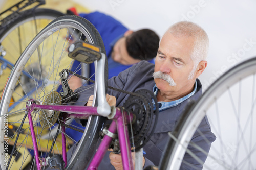 Senior mechanic working on bicycle
