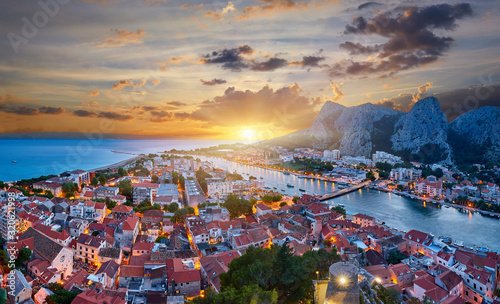 Aerial panoramic view of Old town Omis: Ancient walls and red tiled roof. Montenegro, Europe. One of best preserved medieval cities in the Mediterranean and most popular resorts of Adriatic Riviera. #320621998